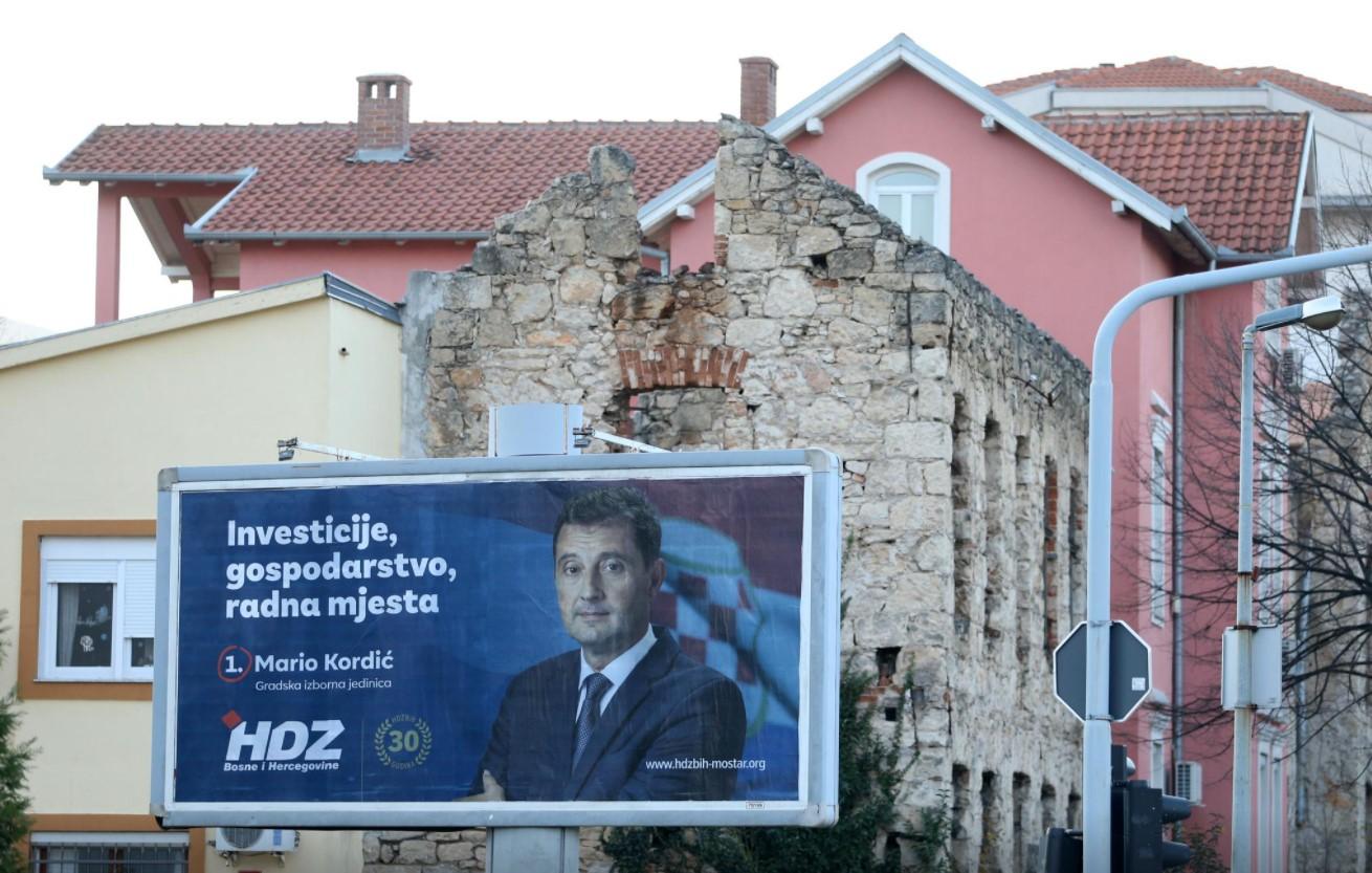 An election sign is seen in front of a house that was destroyed during the 1992-1995 war, in Mostar, Bosnia and Herzegovina December 14, 2020. - Avaz