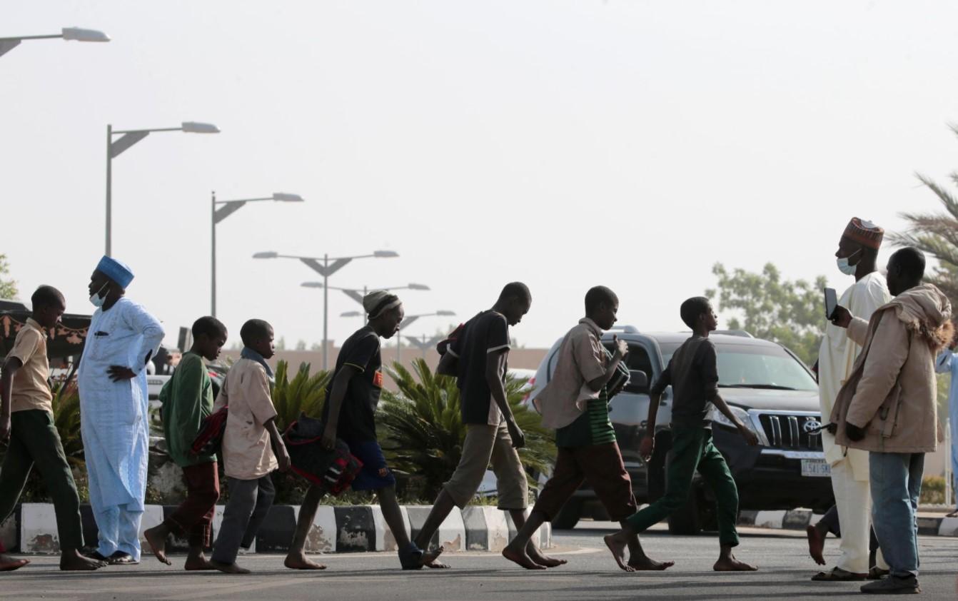 Tired but smiling, freed Nigerian schoolboys arrive back home