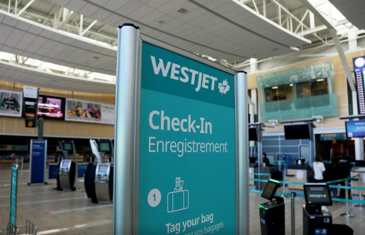 WestJet airline signage is pictured at Vancouver's international airport in Richmond, British Columbia, Canada, February 5, 2019. - Avaz