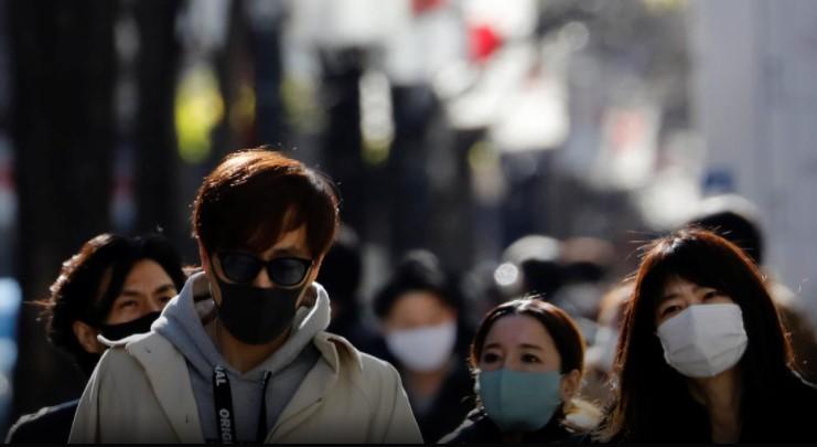 Pedestrians wearing protective masks, amid the coronavirus disease (COVID-19) outbreak, make their way at Ginza shopping district which closed to cars on Sunday in Tokyo, Japan, January 10, 2021. - Avaz