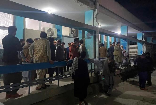 Relatives wait outside a hospital for the bodies of three women that ware killed by gunmen in the city of Jalalabad, east of Kabul, Afghanistan, Tuesday, March 2, 2021. - Avaz