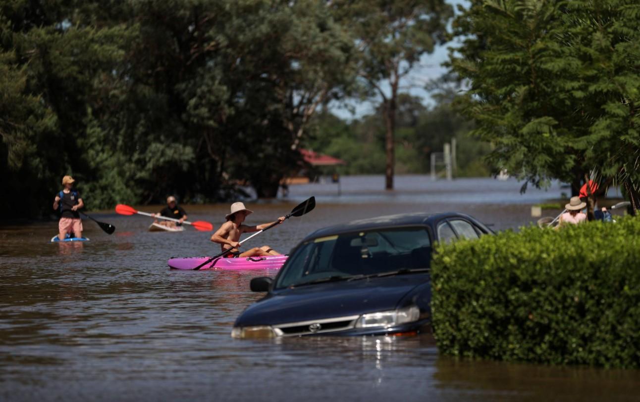 People using kayaks and paddle boards navigate a residential neighbourhood inundated with floodwaters as severe flooding affects the suburb of McGraths Hill in Sydney, Australia, March 24, 2021. - Avaz