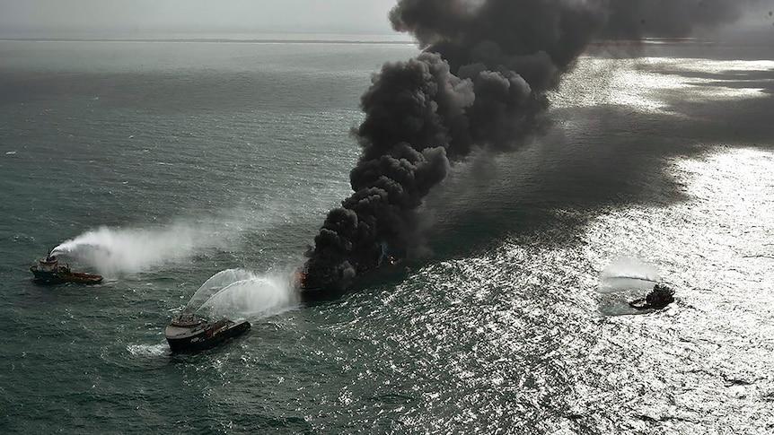 The burning ship is carrying 25 tonnes of nitric acid as well as other unspecified chemicals - Avaz