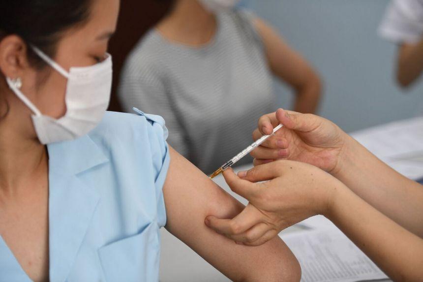 A woman receiving a Covid-19 vaccine dose in Hanoi on May 17, 2021. - Avaz