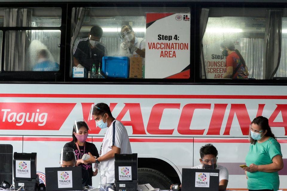 Health workers encode information and prepare vaccines against the coronavirus disease (COVID-19) at a mobile vaccination site in Taguig, Metro Manila, Philippines, May 21, 2021. - Avaz