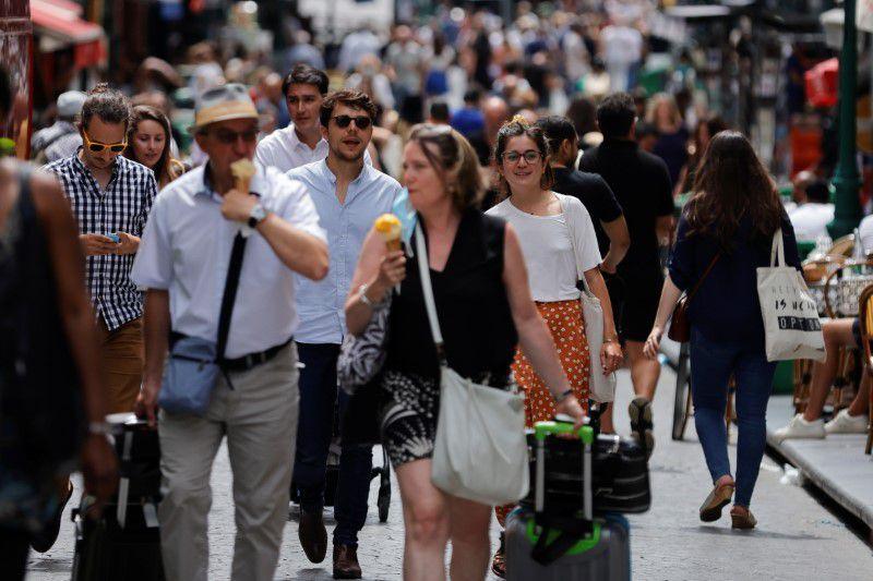 People walk in a street in Paris without protective face masks as they are no longer required outdoors, amid the coronavirus disease (COVID-19) pandemic, France, June 17, 2021. - Avaz