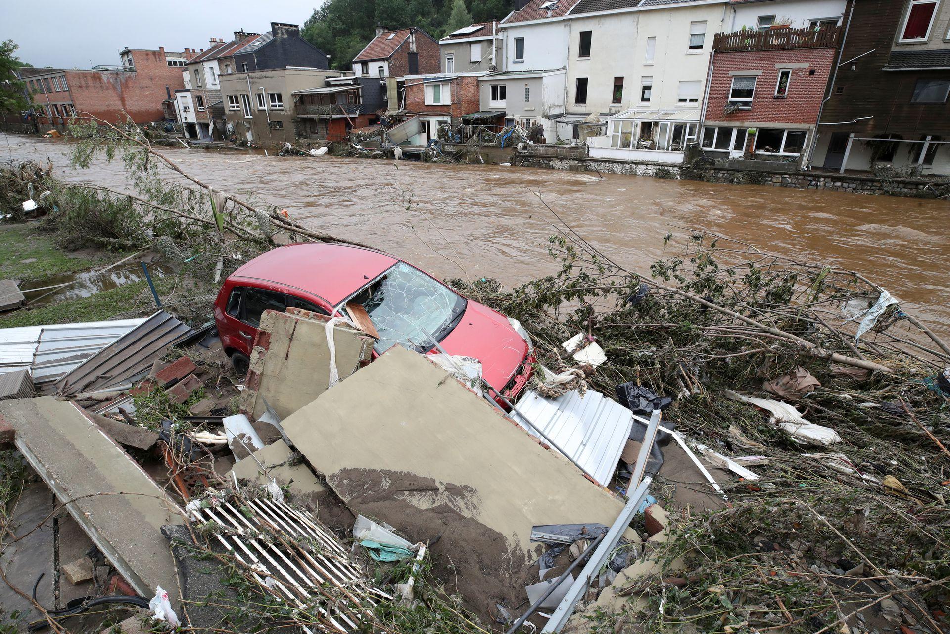 A damaged vehicle is seen next to the river, following heavy rainfalls, in Pepinster, Belgium, July 16, 2021. - Avaz