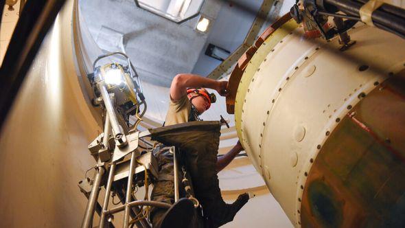 In this image provided by the U.S. Air Force, Airman 1st Class Jackson Ligon, 341st Missile Maintenance Squadron technician, prepares a spacer on an intercontinental ballistic missile during a Simulated Electronic Launch-Minuteman test - Avaz